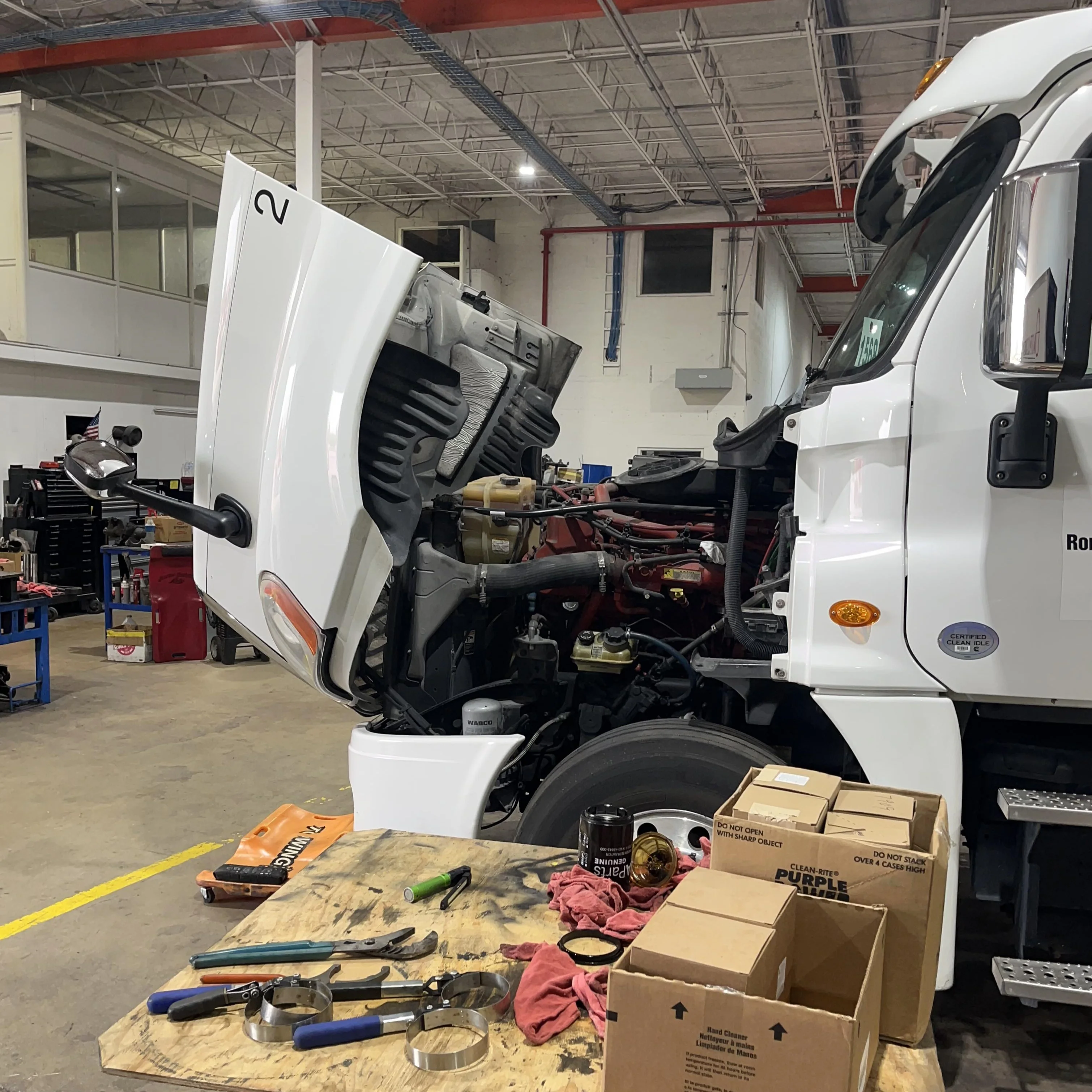 Truck cab tilted for transmission fluid service