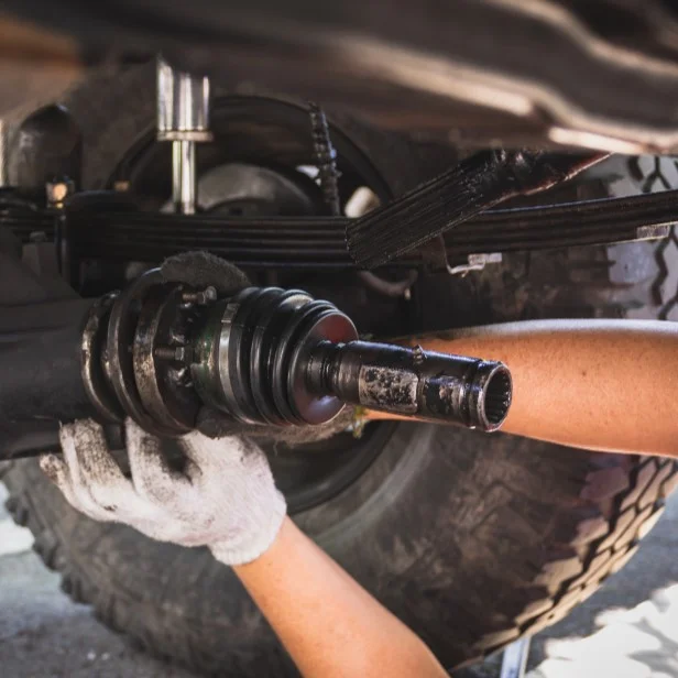 Mechanic repairing truck leaf spring