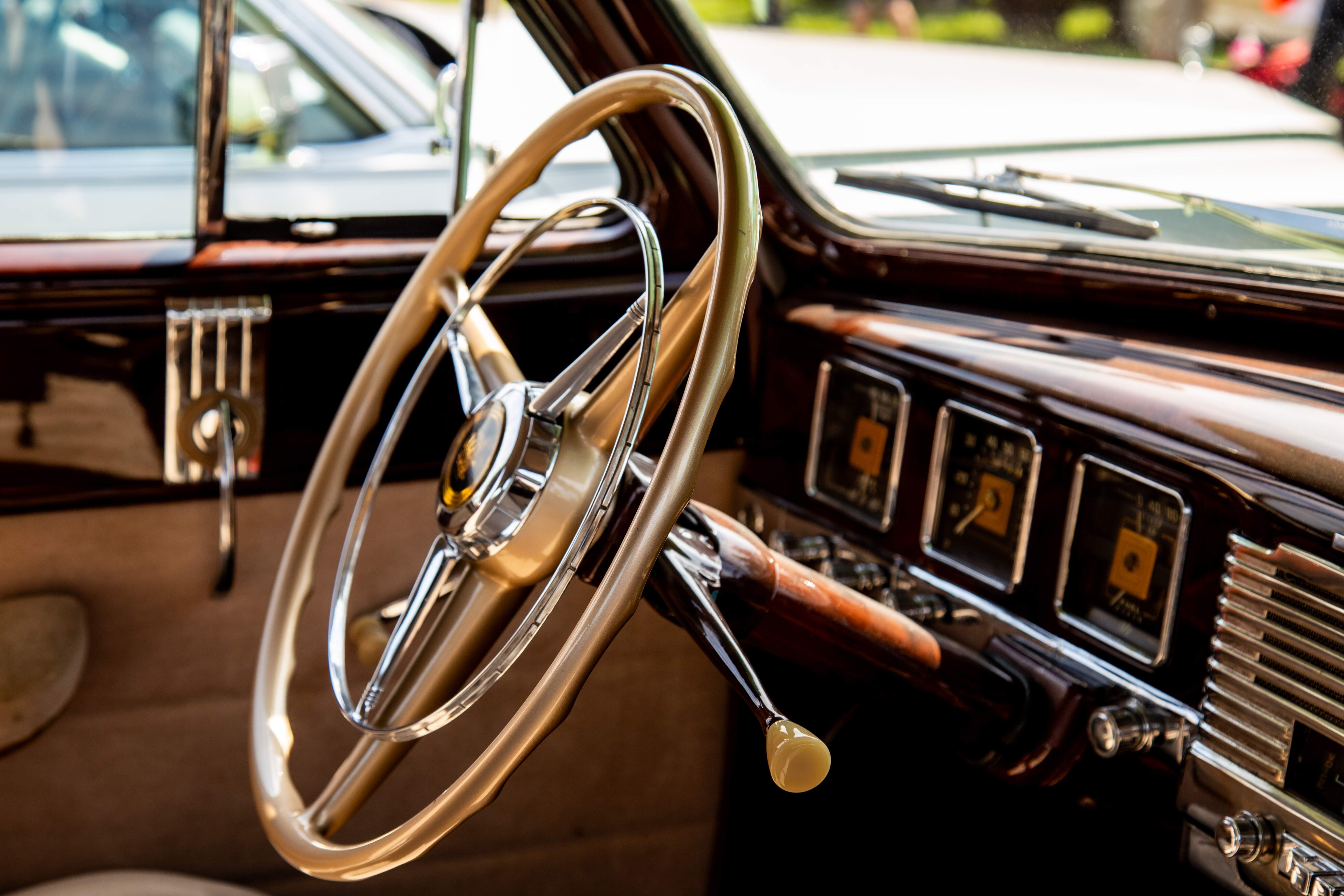 A close-up of the interior of a vintage car, showcasing a classic wooden dashboard, chrome details, and a large steering wheel. Retro Car Club Leumi, Tel Aviv, Israel