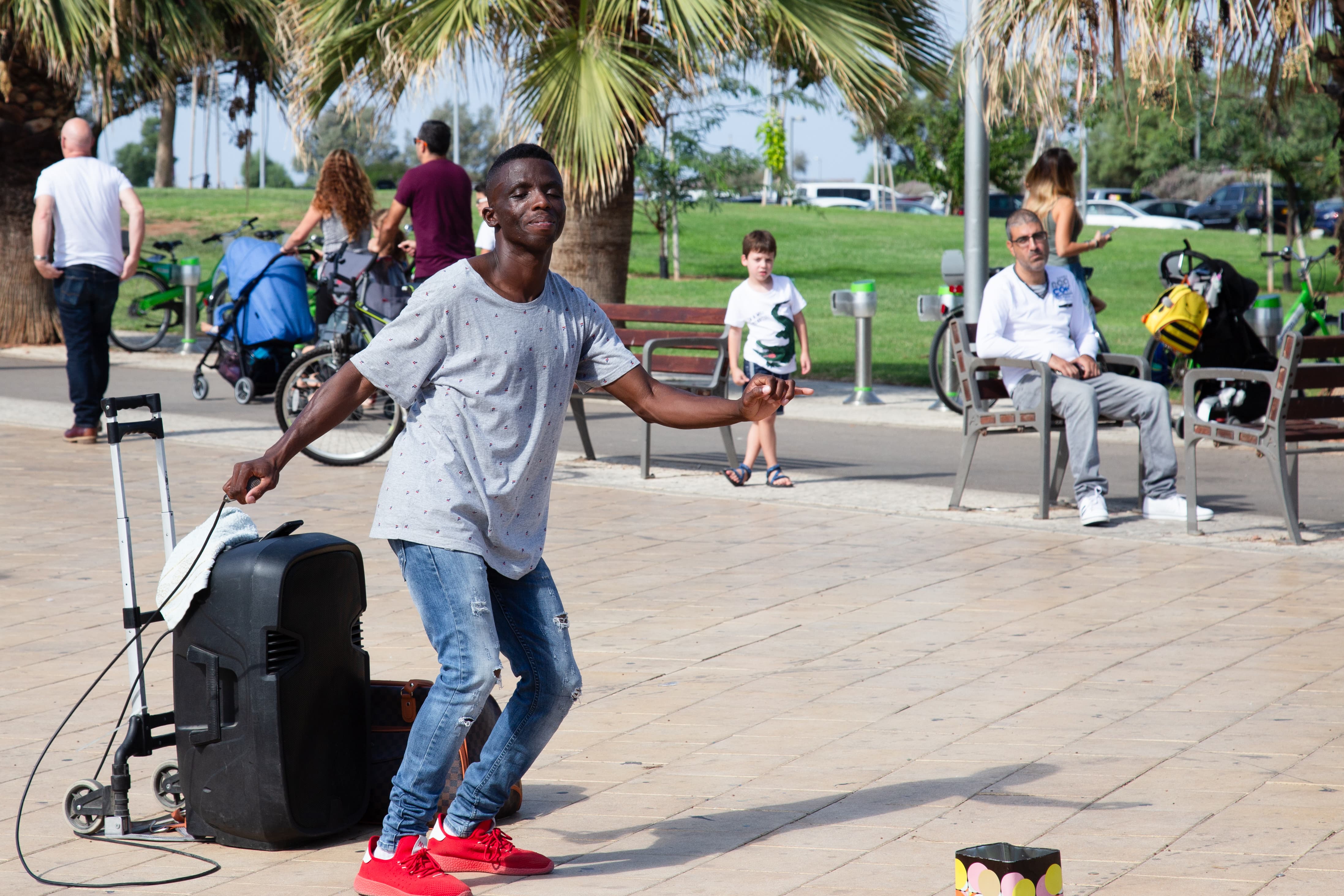 A street performer dances energetically at Tel Aviv Port, captivating passersby with lively moves. Tel Aviv Port, Israel