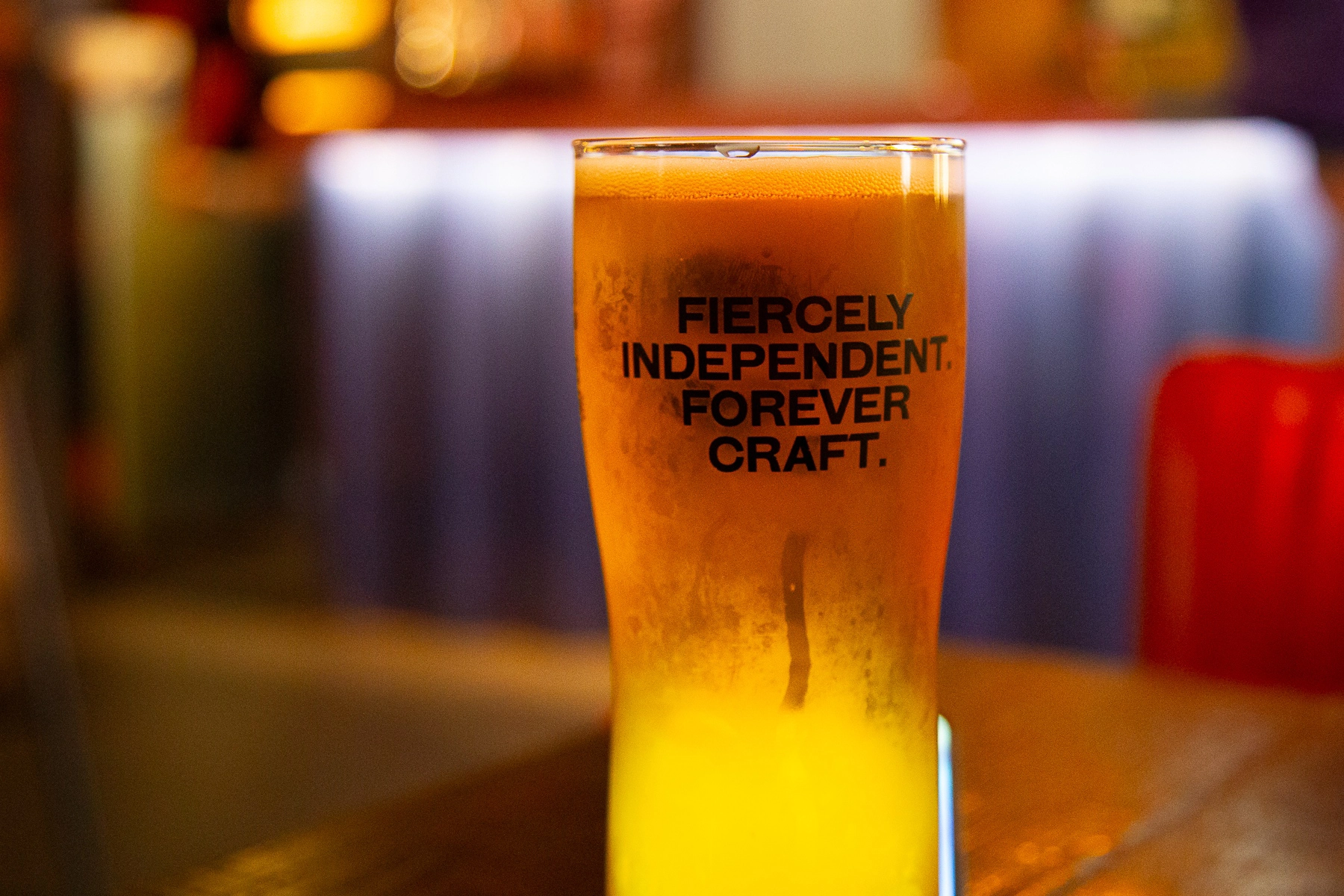 A close-up of a pint glass with the text "Fiercely Independent. Forever Craft." Paris , France