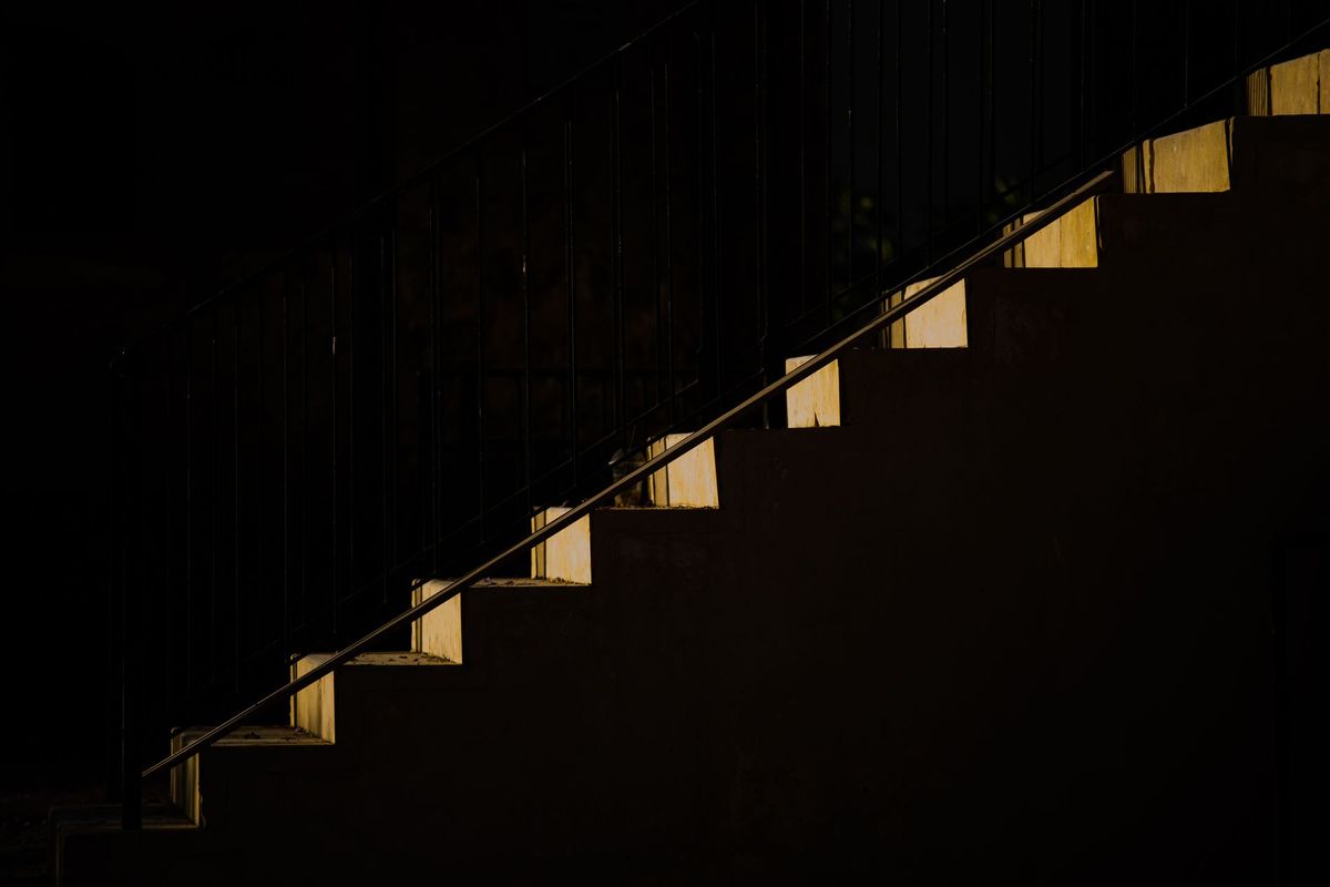 Pathway of Light and Shadow – Minimalist image of a staircase illuminated by slivers of light, creating a striking contrast of light and shadow. Captured by Alex Zlidin, this photograph was shortlisted for The Art of Minimalism challenge and published in Photography Week Magazine, issue 617, July 2024.