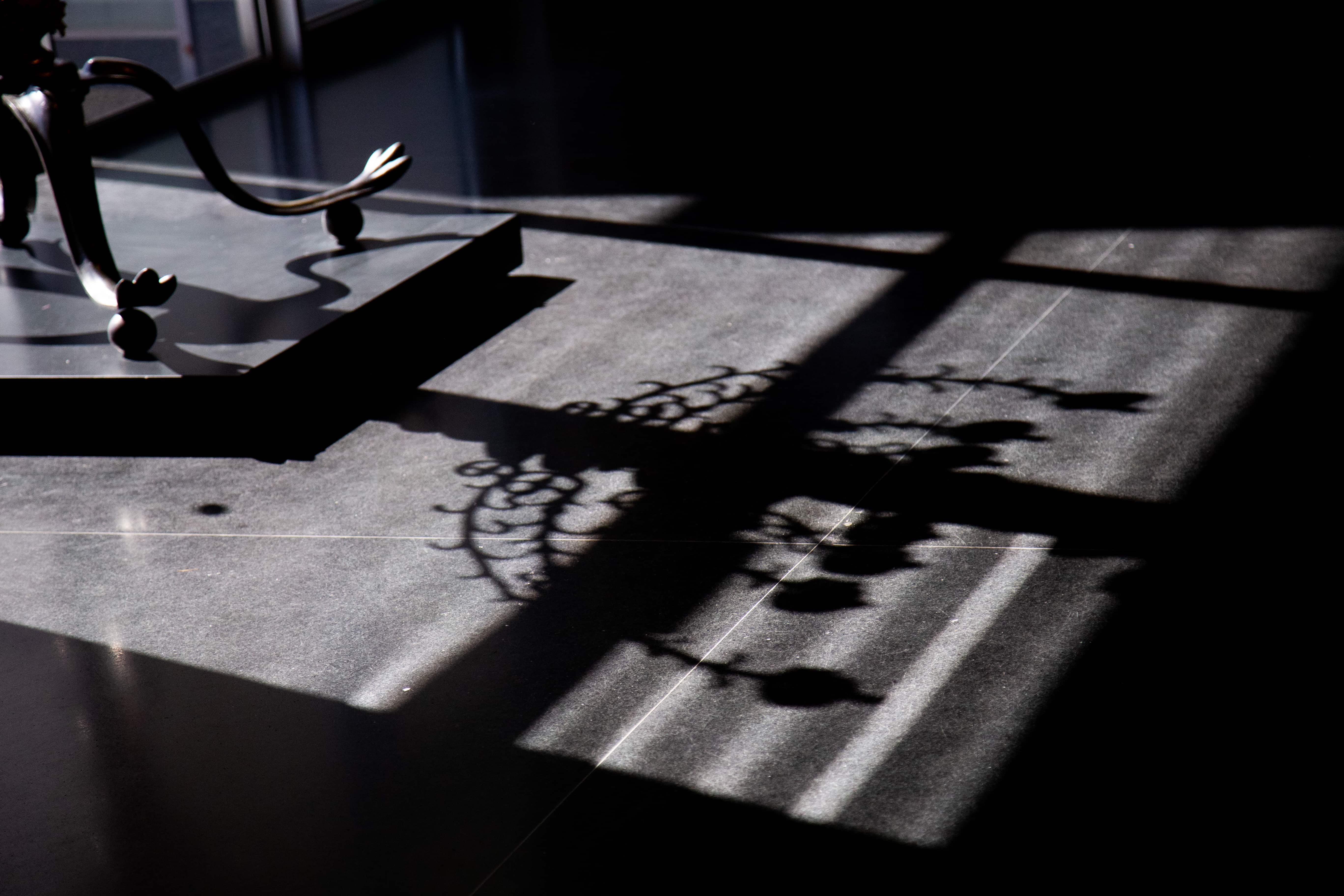 Patterns of light and shadow dance across the floor, projected from a Menora, creating intricate and delicate visual textures. Museum of Israel, Jerusalem, Israel