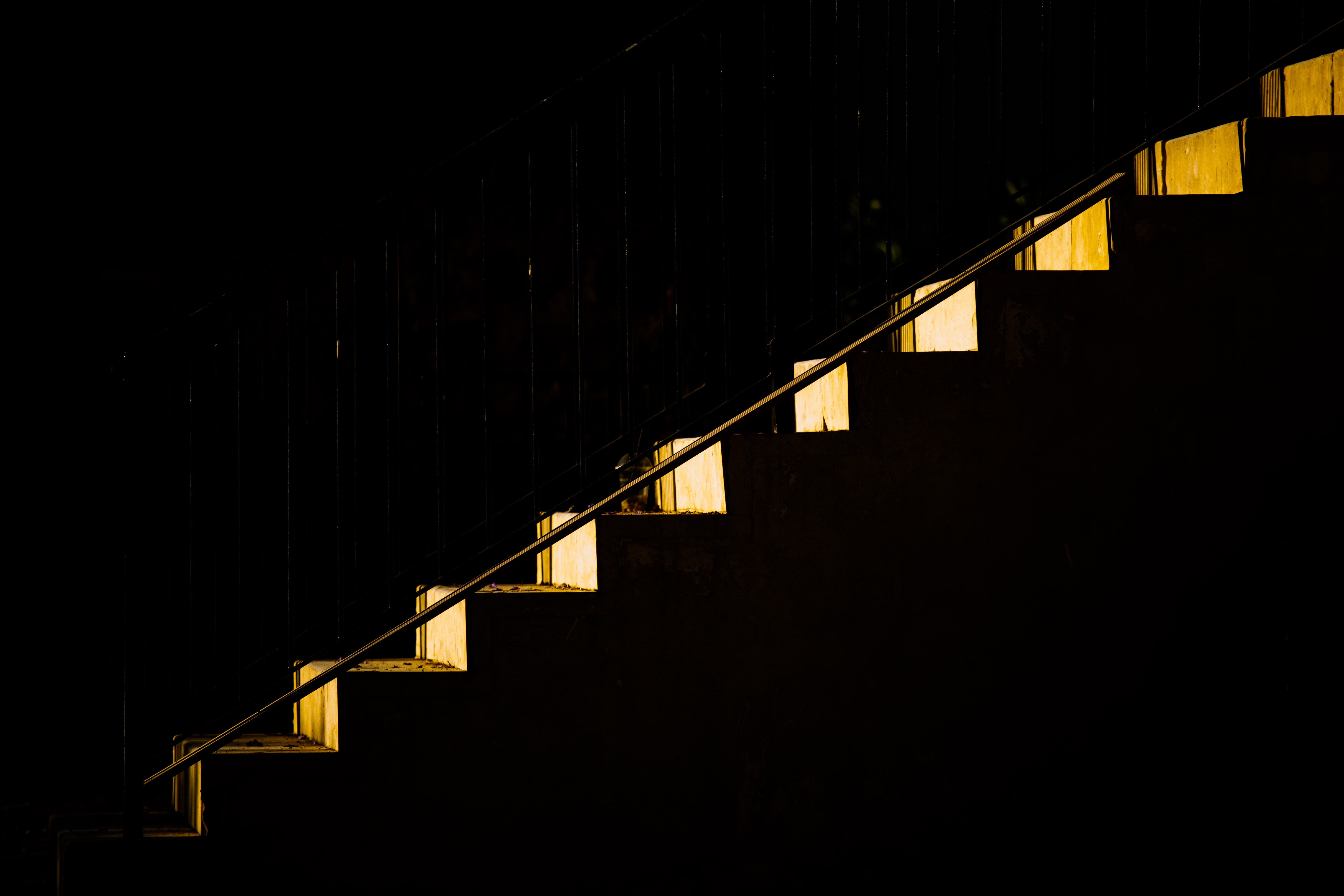 A softly glowing staircase leads upward, evoking quiet contemplation and mystery as if leading to a profound, unseen destination. Sarona, Tel Aviv