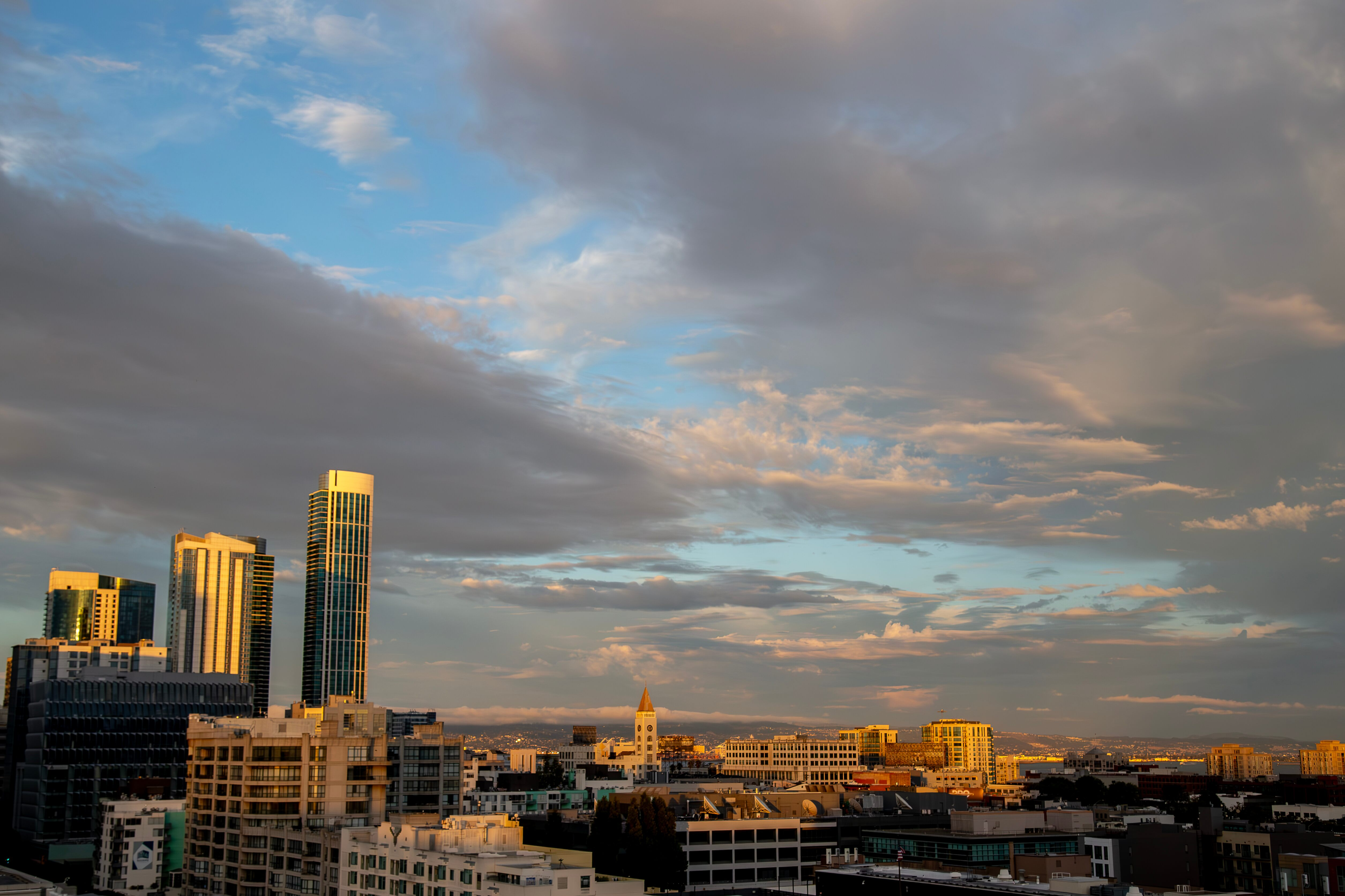 Golden Hour Skyline San Francisco's skyline illuminated by the warm light of sunset, with dramatic clouds filling the sky.San Francisco, USA