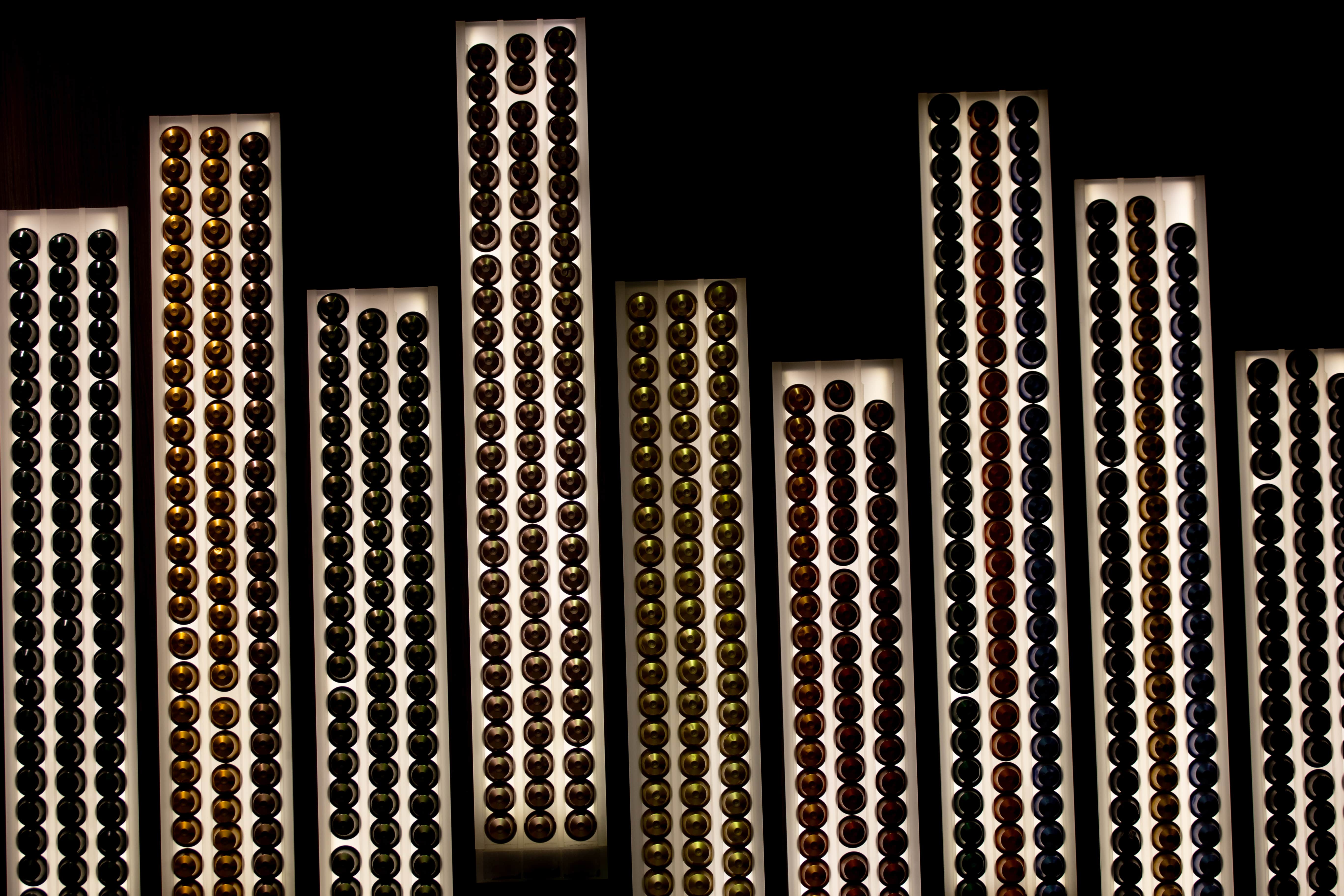 A visually captivating arrangement of colorful coffee capsules displayed on tall illuminated panels. Jerusalem, Israel