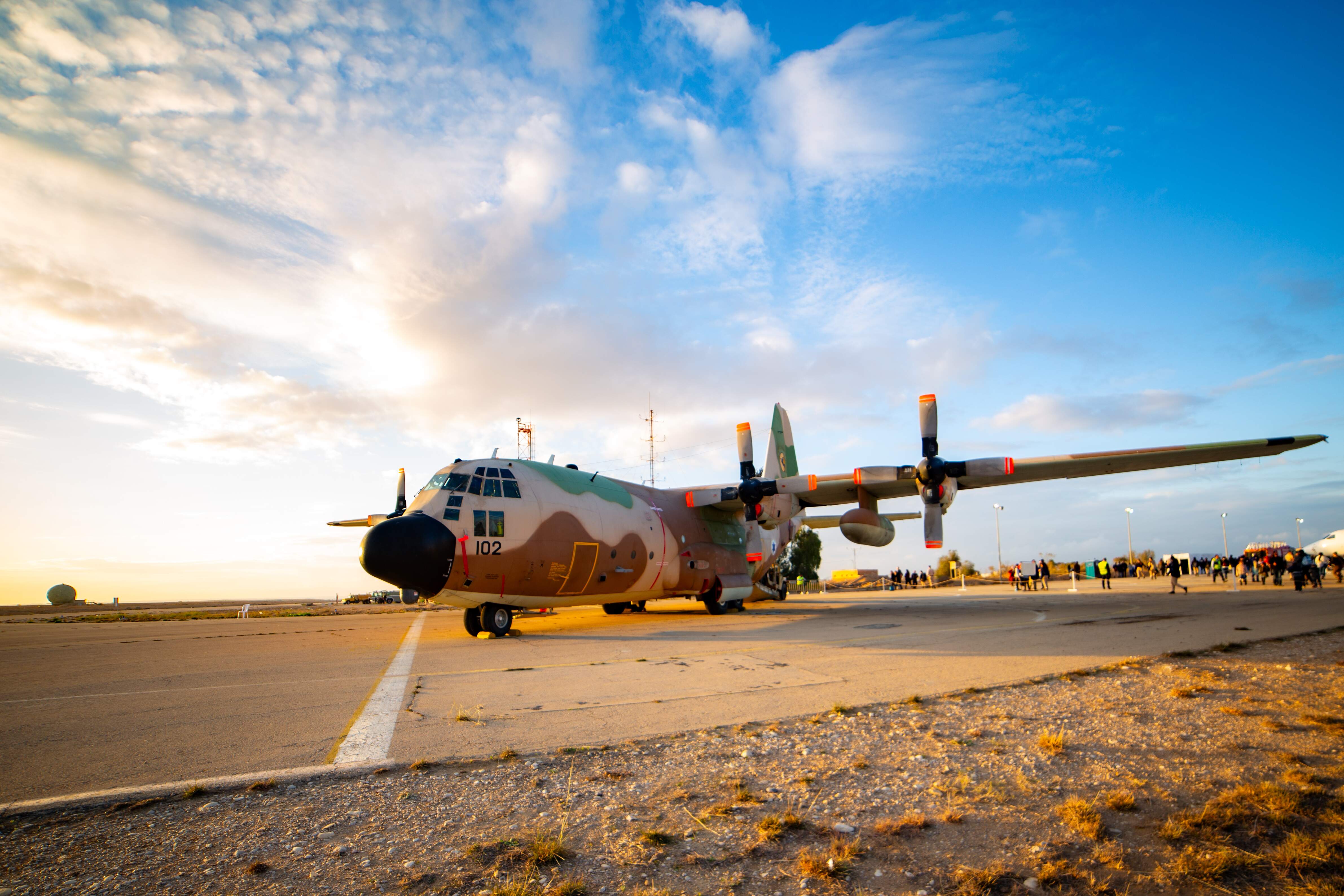 A C-130 Hercules military aircraft on display at sunset during the Israeli Air Force flight course graduation. Graduation Ceremony of the IAF Flight Course