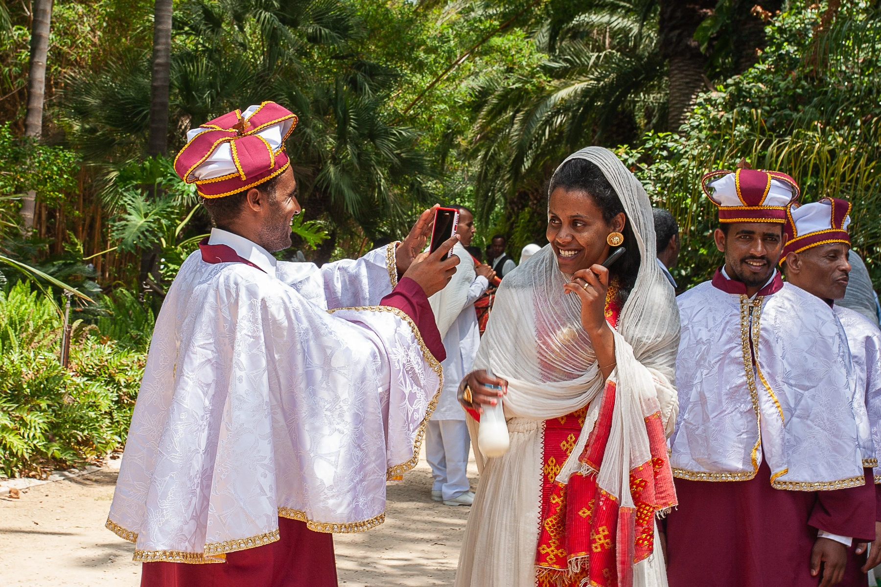 People dressed in traditional attire capturing a celebratory moment, wearing bright clothing. Tropic Park Tel Aviv , Israel