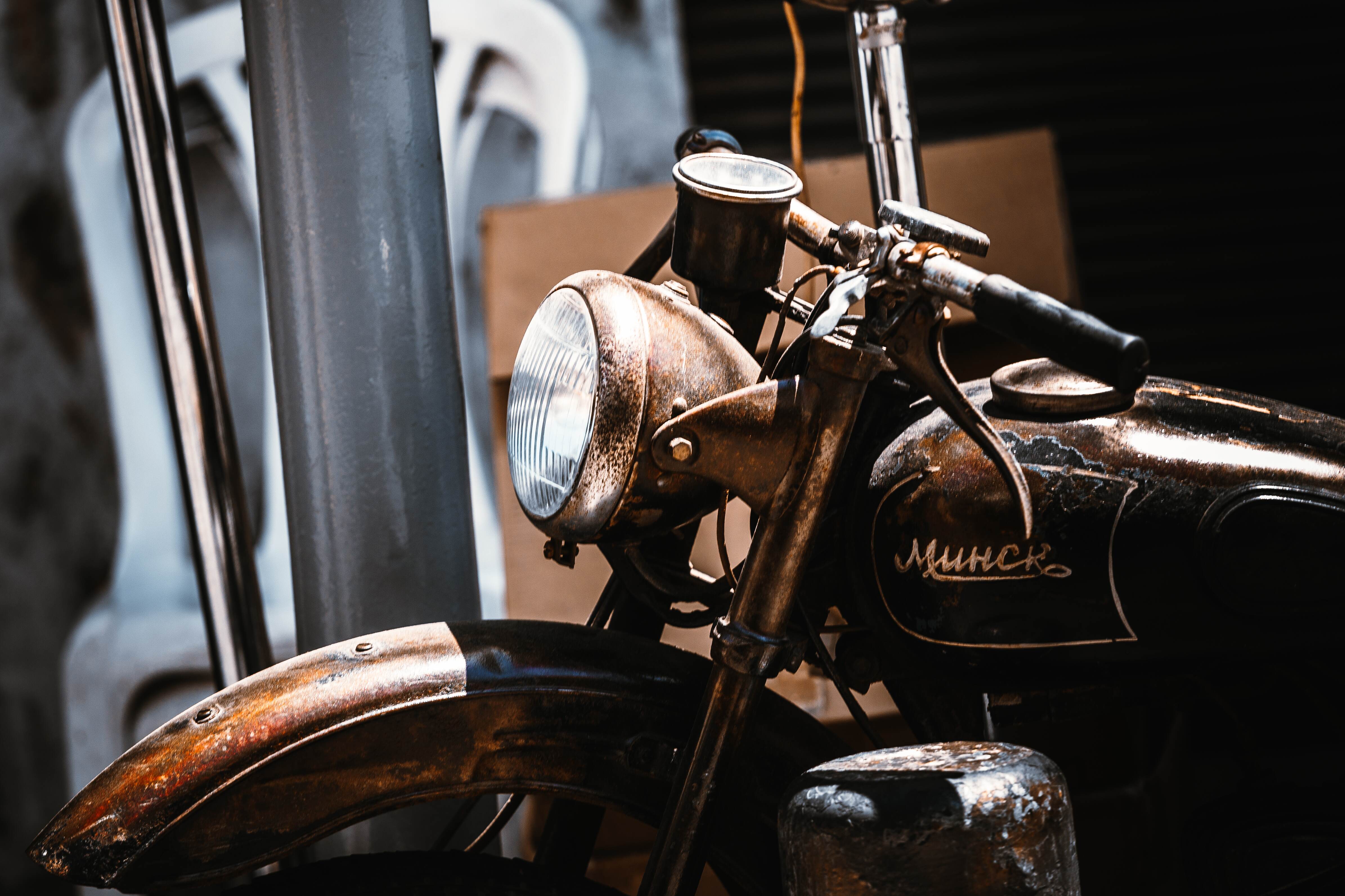 A close-up of a rusted, vintage Minsk motorcycle, showcasing its worn textures and classic design. Tel Aviv, Israel